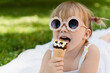 © Westend61 - Child enjoying ice cream outdoors on a sunny day