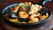 © Puttipong - A steaming bowl of seafood paella with shrimp, mussels, and squid, beautifully presented with saffron rice.