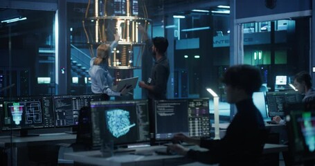 In a Futuristic Science Lab, Diverse Engineers Discussing a Quantum Computer Project, Analyzing Data on a Laptop. Team of Female and Male Specialists Working to Improve and Scale a Quantum Processor