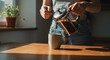 © Syauqi Studio - A person pours coffee from a French press into a ceramic mug on a wooden table with warm sunlight.
