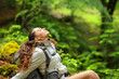 © Antonioguillem - Trekker resting and breathing sitting in a forest