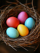 © sorninai - Happy Easter day. Bright multi-colored Easter eggs lie in a bird's nest. Spring. Dark background. Blue, yellow and pink eggs, vibrant colors.