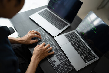 Asian man software engineer Working on Computer at office desk for writing program code IT Software Engineer finding errors tech support devops creating digital