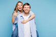 © ViDi Studio - Young happy couple two friends family man woman wear shirt casual clothes together giving piggyback ride to joyful, sit on back isolated on pastel plain light blue background studio Lifestyle concept