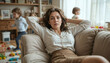 © Elio - Stressed career mom trying to relax while children play around her