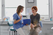 © Halfpoint - Female doctor consulting with a female patient, discussing test result in doctor office.