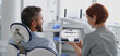 © Halfpoint - Female dentist showing x-ray to patient in dental clinic during anual check-up.