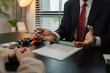 © kamiphotos - a car salesperson is explaining the details of a car purchase contract to the buyer before signing the sales contract, showroom, dealer, car contract, sining a car purchase contract