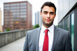 © Minerva Studio - Confident businessman posing outdoors in a modern urban setting