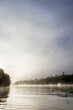 © Austockphoto - Beautiful old wooden boat on the water in fog