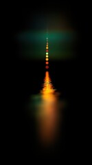 Fototapete - A long, vertical gradient of colors, ranging from dark green to orange, with the light reflecting on water in the center, against a black background.
