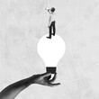 © master1305 - Businessman standing on lightbulb held by hand, shouting through megaphone. Concept of business, innovation, leadership, communication, creative ideas. Conceptual art. Monochrome design