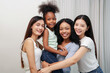 © Prapol Srinakara - portrait of bonding multiracial girls standing in the living room