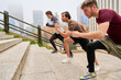© Oscar - Athletes running up stairs in urban environment