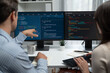 © InfiniteFlow - Team skilled developers program coding discussing creative website planning software project on two screen monitor's full stack data analyzing design at office with back side view concept. Postulate.
