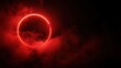© iLada - Red glowing circle in dark sky surrounded by swirling clouds creating a mysterious and dramatic atmosphere for artistic backgrounds and designs