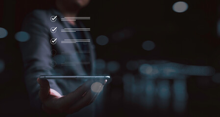 Fototapete - Businessman holding smartphone with correct sign mark for checklist and document approve of quality ISO and project approval concept.