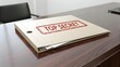 © Azmanrazak - Top Secret Folder on Desk in Modern Office