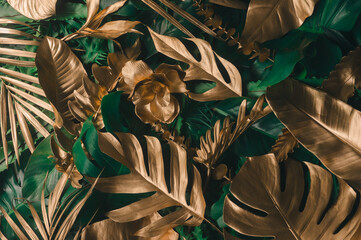 Wall Mural - creative nature background. gold and green tropical monstera and palm leaves. minimal summer abstrac