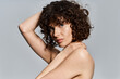 © LIGHTFIELD STUDIOS - Young woman with curly hair poses artistically, radiating confidence and grace.