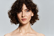 © LIGHTFIELD STUDIOS - Elegant woman highlights her flawless complexion and glowing skin against a serene backdrop