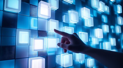 Hand selecting digital glowing cube buttons on a technology wall against blue background