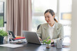 © mojo_cp - Portrait of confident Asian business woman working in office
