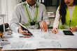 © Suphakant - Engineers work as a team with blueprints for architectural plans. Engineer sketching construction project concept with architect equipment Architects talking at table Teamwork and construction concept