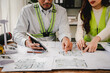 © Suphakant - Engineers work as a team with blueprints for architectural plans. Engineer sketching construction project concept with architect equipment Architects talking at table Teamwork and construction concept