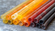 © wildan - Colorful resin straws stacked on gray surface