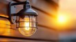© michnik101 - Vintage-style outdoor wall lantern glowing warmly at sunset against wooden siding. Cozy exterior lighting for ambiance.
