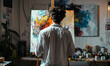 © Honey Bear - Young Male Artist Creating Abstract Expressionist Painting in Modern Art Studio, Back View of Painter in White Shirt Working on Vibrant Colorful Canvas Surrounded by Paints