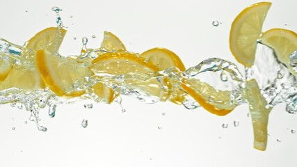 Fototapete - Super Slow Motion of Flying Lime Slices in Water Splashes, White Background. Filmed on High Speed Cinema Camera, 1000 fps.