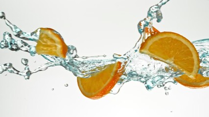 Fototapete - Super Slow Motion of Flying Orange Slices in Water Splashes, White Background. Filmed on High Speed Cinema Camera, 1000 fps.