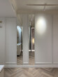 © 4595886 - Bright hallway features sleek doors and subtle decorative wall elements. The flooring combines natural wood tones, while soft lighting creates a warm ambiance.