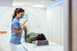 © Dragana Gordic - Healthcare Professional Assisting Patient During MRI Scan in Modern Medical Facility