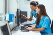 © Dragana Gordic - Team of Nurses Collaborating at Computer in Modern Medical Work Environment