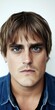 © imagineRbc - A young man with light brown hair and expressive blue eyes looks directly at the viewer, his serious expression suggesting confidence and intensity