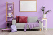 © Pixel-Shot - Stylish sofa, rack with decor, houseplant and blank poster on lilac wall