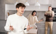 © JackF - Adult man and young woman during family quarrel with young guy in kitchen