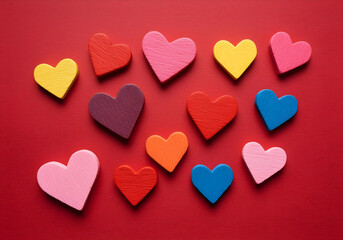 Wall Mural - Colorful handmade hearts on a vibrant red background.