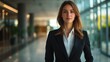 © Alexander Chaykin - A focused corporate woman standing confidently in an office lobby.