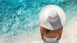 © Diffin - Woman in a white hat gazes at the ocean horizon, enjoying the serene view.