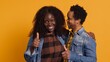 © DC Studio - Affectionate husband and wife giving a like symbol on camera, african american couple posing with thumbs up in studio. Married people giving their approval and nodding in agreement. Camera A.