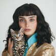 © athiranage - Stunning Woman and Playful Cat in Fashionable Blue Outfit and Golden Jacket Indoor Portrait - Embracing Affectionate Pet Bond in Cozy Lifestyle