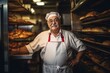 © Vorda Berge - Portrait of a senior baker standing by oven