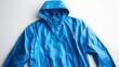 © Mr image - Blue Raincoat: A striking blue raincoat, crafted for functionality, rests, ready to shield one from the elements. This image focuses on the texture and form of the outerwear.