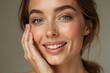 © ihaveJPG - Radiant woman with glowing skin smiling and touching her face softly