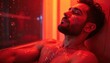 © miss irine - Biohacker uses infrared sauna, ambient red light therapy to help him relax. Man in sauna sweats on skin during wellness practice. Detoxification, recovery, rejuvenation for healthy lifestyle.