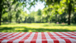 © Atchariya63 - red and white checkered tablecloth on sunny day in park, creating cheerful atmosphere